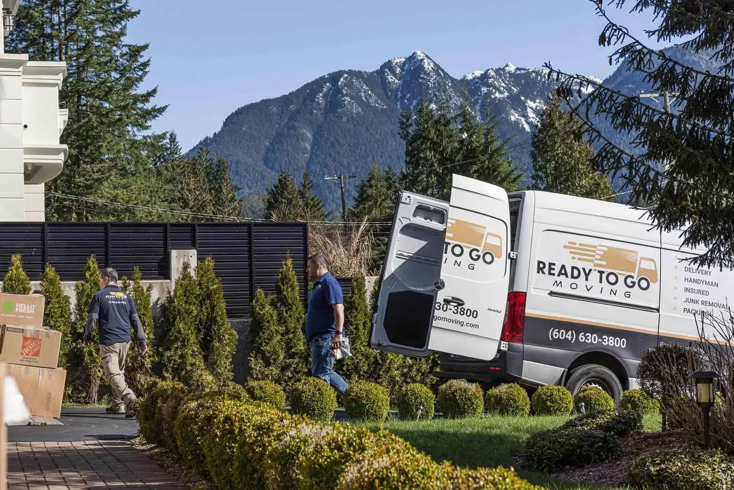 Ready To Go crew loading the van with the North Shore mountains behind