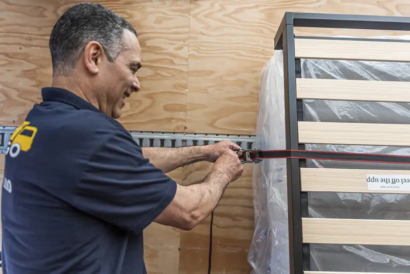 Mover securing furniture in the truck